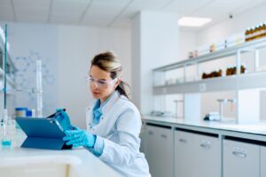 Scientist using digital tablet in laboratory for research